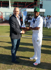 WICB Director of Cricket Richard Pybus presents Guyana Jaguars captain Leon Johnson with Headley-Weekes Trophy