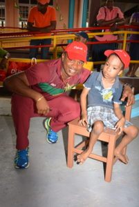 Christopher Barnwell takes time out to have a photo with a young student