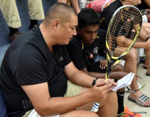 Assistant Manager David Fernandes offering court side tips to one of the Guyanese players