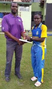 Former West Indies fast bowler Reon King, who was the Match Referee for this game, presents the Player-of-the-Match trophy to Kycia Knight of Barbados