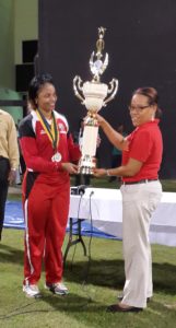 T&T captain Merissa Augilliera receives the championship trophy from Josina Luke of the WICB