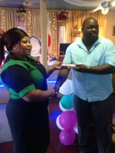 Director of Public Health Services Jevaughn Stephen right handing over a certificate to a graduate