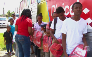 Photo of Children receiving their backpacks
