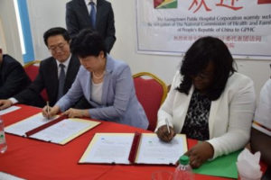 Minister within the Ministry of Public Health Dr. Karen Cummings and Vice Minister of National Health and Family Planning Commission of the People’s Republic of China sign a certificate which takes into consideration the gifts that have been contributed to Guyana