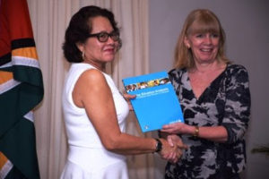 First Lady Sandra Granger receives copy from UNICEF Representative Marianne Flach