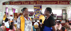Lion Marcia Edwards and News Room Journalist Stacy Carmichael-James