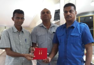 From left: Dharam Persaud, Ricky Deonarain and Steve Narine pose with the pendants