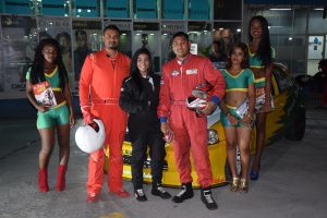 Racing drivers (from left) Shairaz Roshandin, Sharima Khan and Paul Jewanram pose with Rent-a-Tent models on Saturday evening at the Giftland Mall. 