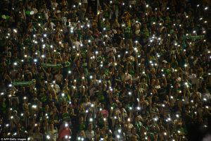 Mourning soccer fans in Medellin and the southern Brazilian town of Chapeco, where the team is from, held simultaneous stadium tributes to the victims. Atletico Nacional fans are pictured holding candles as part of a tribute (Daily Mail photo