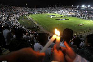 Mourning soccer fans in Medellin and the southern Brazilian town of Chapeco, where the team is from, held simultaneous stadium tributes to the victims. Atletico Nacional fans are pictured holding candles as part of a tribute (Daily Mail photo