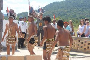 Male Villagers of Surama perform a dance for Prince Harry and his team upon their arrival