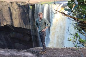 Prince Harry appears to be stunned by the beauty of the majestic Kaieteur Falls that he looks backwards and gives a nod of approval