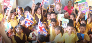 Prince Harry enjoying a moment with pupils before leaving for another location 